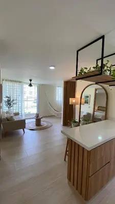 a living room with a large mirror on a counter at Minimalist and cozy apartment in Barranquilla