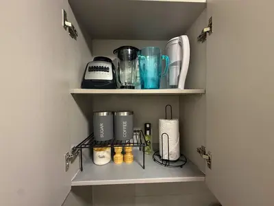 a shelf with various appliances on it in a kitchen at Apartment on the 21st floor, ocean and Sierra views in Simón Bolivar