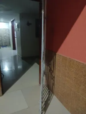 a hallway with a door to a room with a wall at Hostal Mr Key in Barranquilla
