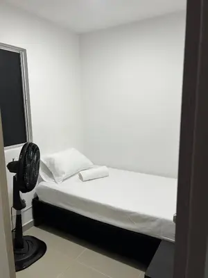 a white room with a bed and a fan at Apartamento cerca a playas de marbella in Cartagena de Indias