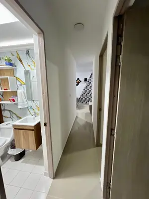 a hallway leading to a bathroom with a sink at Apartamento cerca a playas de marbella in Cartagena de Indias
