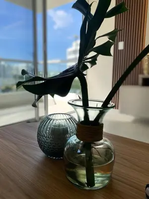 a glass vase with a plant in it on a table at Exclusive oasis , Beach, pool and high comfort in Serena del Mar