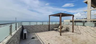 a bench on a balcony next to the ocean at Live Stay - Boquilla SunSet in Cartagena de Indias