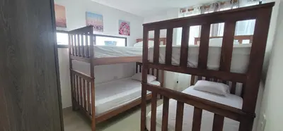 two bunk beds in a room with white sheets at Live Stay - Boquilla SunSet in Cartagena de Indias