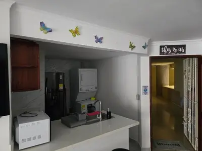 a kitchen with a shelf with butterflies on it at Apartment in El Cabrero in Cartagena de Indias
