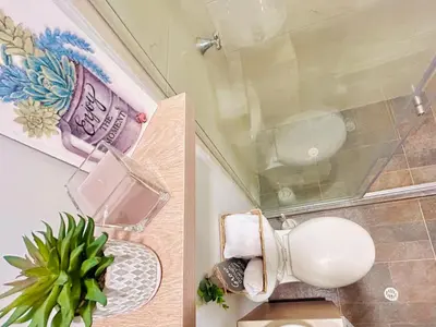a bathroom with a toilet and a plant in it at Hotel Casa Obed in Cartagena de Indias