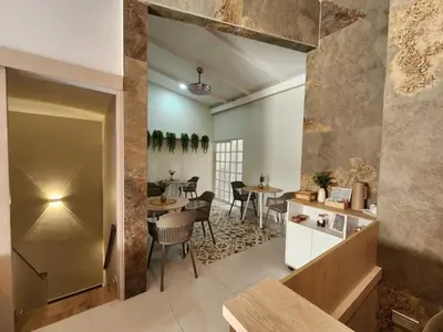 a kitchen and dining room with tables and chairs at Hotel Casa Obed in Cartagena de Indias