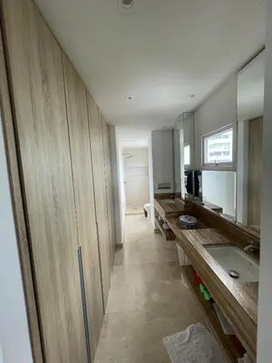 a kitchen with wooden cabinets and a sink in a room at Oceanfront Oasis in Cartagena de Indias