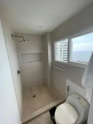 a bathroom with a toilet and a window at Oceanfront Oasis in Cartagena de Indias