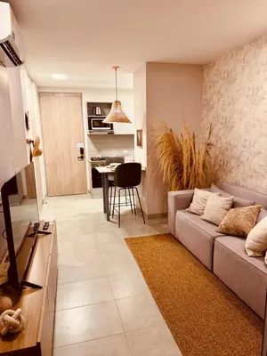 a living room with a couch and a table at Apartamento Bohemio frente al Mar en Santa Marta in Santa Marta