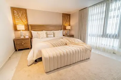 a bedroom with a large bed and a large window at Berthas collection by em hotels in Cartagena de Indias