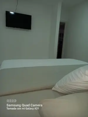a close up of a bed with a pillow at Hotel H&H in Cartagena de Indias