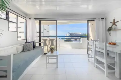 a living room with a couch and a table at Tropical Beach - Con vista al mar in Cartagena de Indias