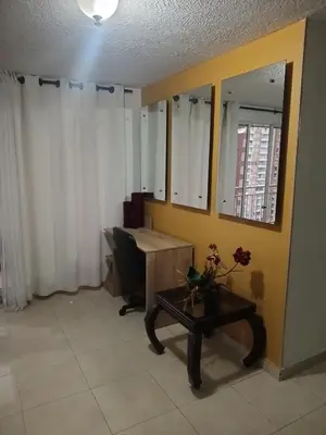 an office with a desk and a table and a mirror at Apartamento 3 alcobas barrio Miramar Barranquilla in Barranquilla