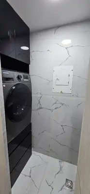 a washing machine in a bathroom with marble walls at Acuarium in Cartagena de Indias