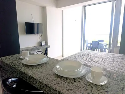 a table with plates and cups on top of it at Olas & relax Cartagena in Cartagena de Indias