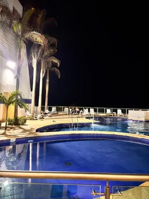 a large swimming pool with palm trees in the background at Apartment in Cartagena 5 minutes from the historic center in Cartagena de Indias