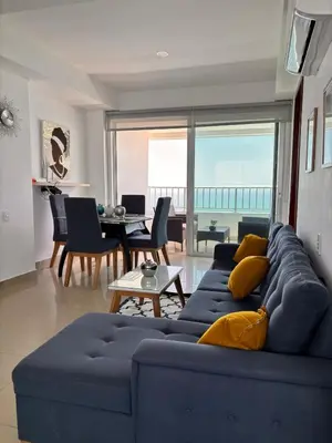 a living room with a blue couch and a table at Apartment in Cartagena 5 minutes from the historic center in Cartagena de Indias
