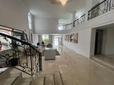 a large living room with a staircase in a house at Casa Mansion in Barranquilla