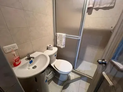 a bathroom with a shower and a toilet and a sink at Casa Mansion in Barranquilla