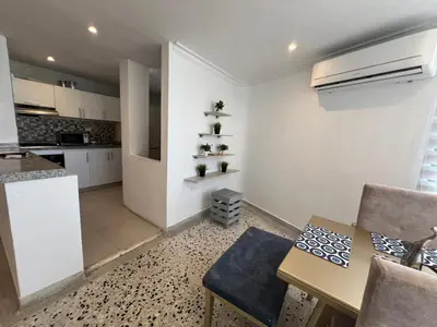 a kitchen and a dining room with a table and a counter at Luz in Barranquilla