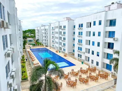 an apartment with a swimming pool and tables and chairs at Acogedor apto en Coveñas 401 in Coveñas