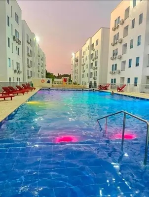 a large swimming pool in front of some buildings at Acogedor apto en Coveñas 204 in Coveñas