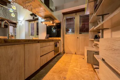 a kitchen with wooden cabinets and a counter top at Apartamento Virrey in Cartagena de Indias