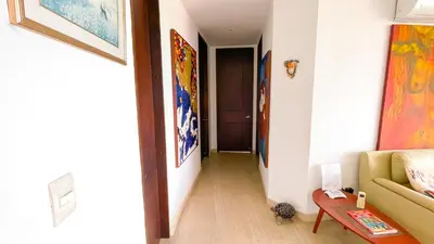 a hallway with a living room with a couch and a table at Hermoso Apartamento Frente al Mar 3 Habitaciones MSC34 in Estación El Salto