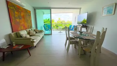 a living room with a couch and a table and chairs at Hermoso Apartamento Frente al Mar 3 Habitaciones MSC34 in Estación El Salto