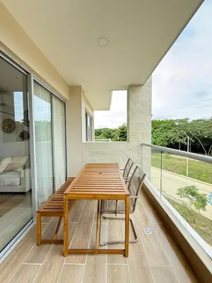 a dining room with a table and chairs on a balcony at 2BR 2BA Apt Baia Kristal Cartagena Crystal Lagoon in Cartagena de Indias