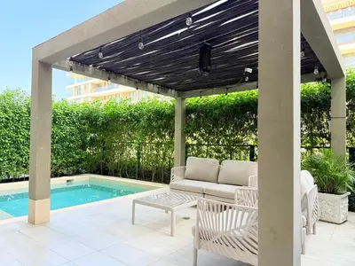 a patio with a couch and a table next to a pool at Shoreline Escape - Private Pool - Beach in Cartagena de Indias