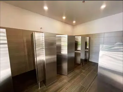 a row of elevators in a bathroom with wooden floors at New luxury studio apartment with ocean view, Santa Marta in Simón Bolivar