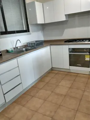 a kitchen with white cabinets and a sink at Casa - EL LAGUITO in Cartagena de Indias