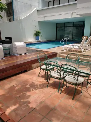 a pool with a table and chairs next to a swimming pool at Casa - EL LAGUITO in Cartagena de Indias