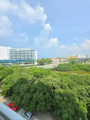 a view of a building from a balcony with trees at Estilo y confort en cartagena, a pasos del mar in Cartagena de Indias