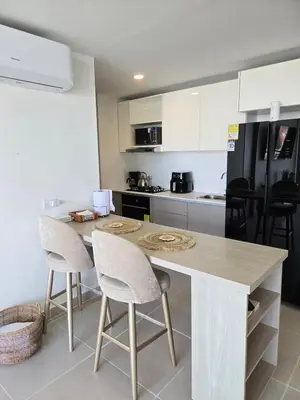 a kitchen with a table and chairs in a kitchen at Estilo y confort en cartagena, a pasos del mar in Cartagena de Indias