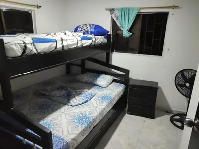 a bedroom with two bunk beds and a window at Cartagena brisa y caracol in Cartagena de Indias