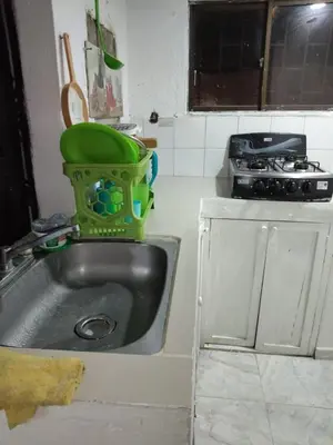 a kitchen with a sink with a green bucket on it at Cartagena brisa y caracol in Cartagena de Indias