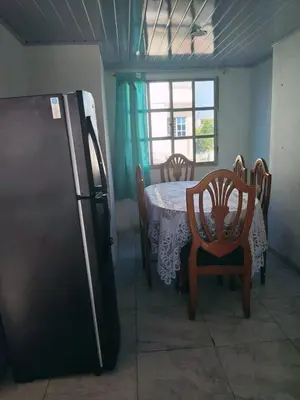 a kitchen with a table and chairs and a refrigerator at Cartagena brisa y caracol in Cartagena de Indias
