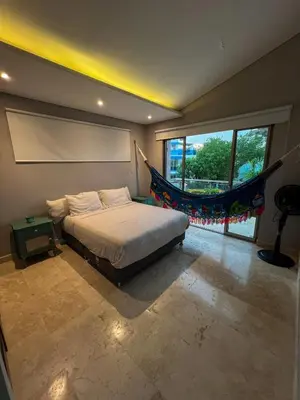 a bedroom with a bed and a large window at Cabaña privada con piscina y jacuzzi junto al mar in Santa Veronica