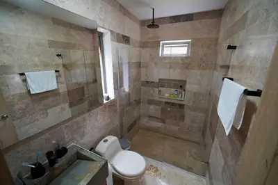 a bathroom with a shower with a toilet and a sink at Casa Juliana vista al mar piscina y jacuzzi in Tubará