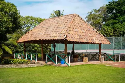 a pavilion with a thatched roof in a park at Casa Juliana vista al mar piscina y jacuzzi in Tubará