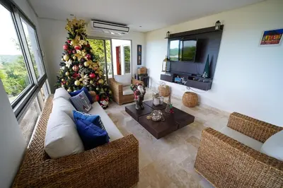 a living room with a christmas tree and a television at Casa Juliana vista al mar piscina y jacuzzi in Tubará