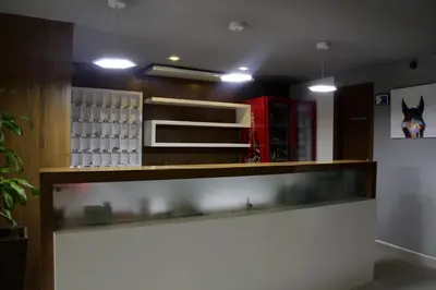 a bar in a restaurant with a counter and lights at Hotel San Marcos Barranquilla in Barranquilla