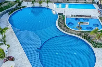 an overhead view of a large blue swimming pool at Apartamentos Exclusivos Santa Marina - AR Rentals in Santa Marta