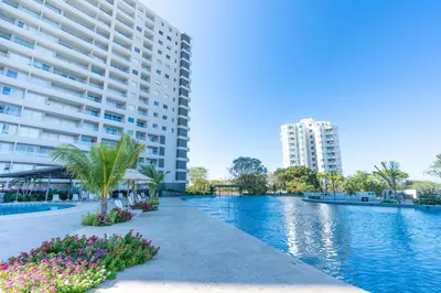 a large apartment building and a swimming pool with a building at Apartamentos Exclusivos Santa Marina - AR Rentals in Santa Marta