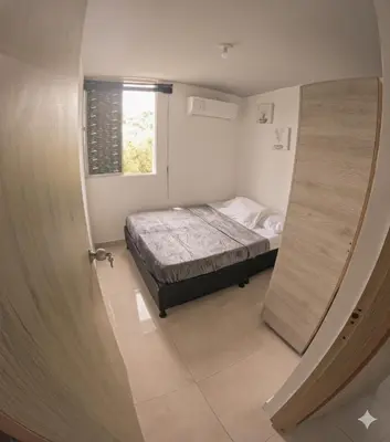 a small bedroom with a bed and a window at Apartamento Caribeño 1203 in Coveñas