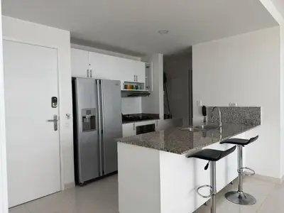 a kitchen with white cabinets and a stainless steel refrigerator at Morros 3, Beachfront & 2 Bedrooms in Cartagena de Indias