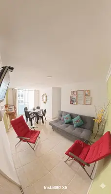 a living room with a couch and red chairs at Apartamento, Arena Dorada, Coveñas in Coveñas